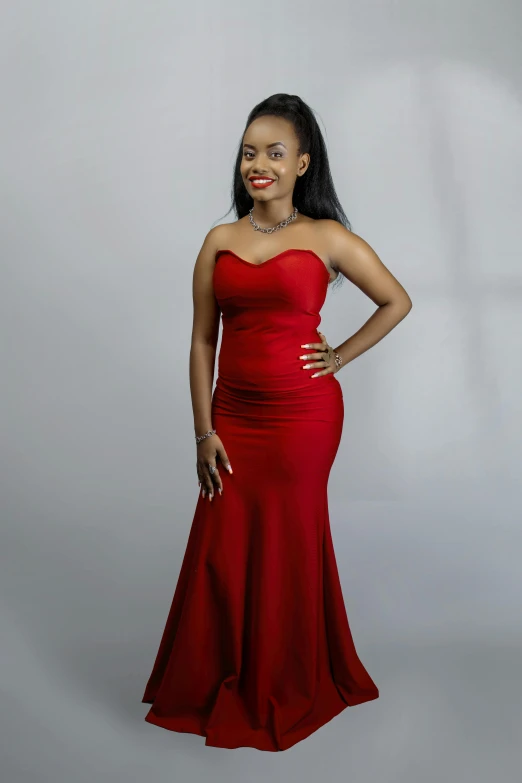 a woman in a red dress posing for a picture