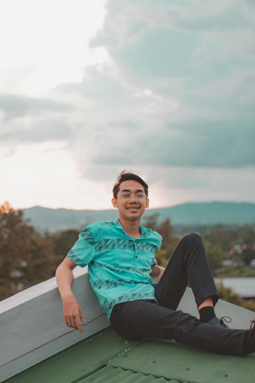 a man sitting on top of a roof