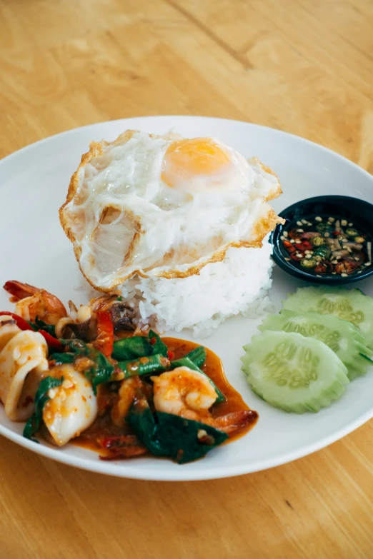 this is a white plate with seafood and rice