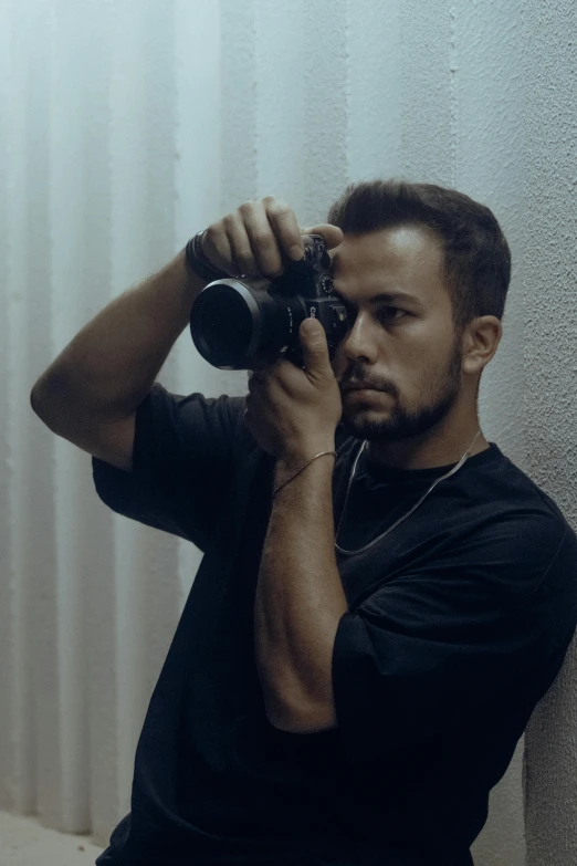 man in black shirt taking picture with camera