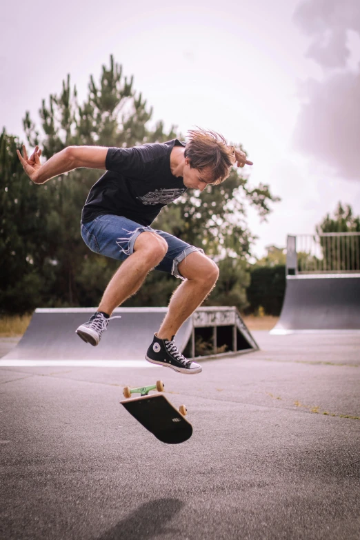 young man in the air doing a jump with his skateboard