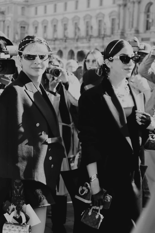 a black and white po of two women in sunglasses