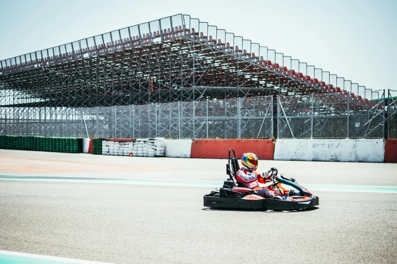 a man racing a mini car around a track