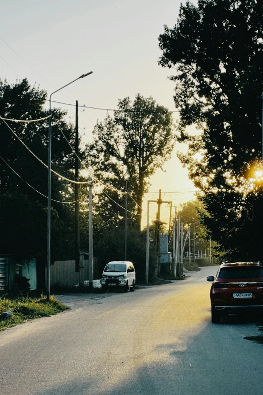 cars parked in front of a light on a street