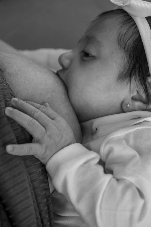 a baby holding a  in her hand