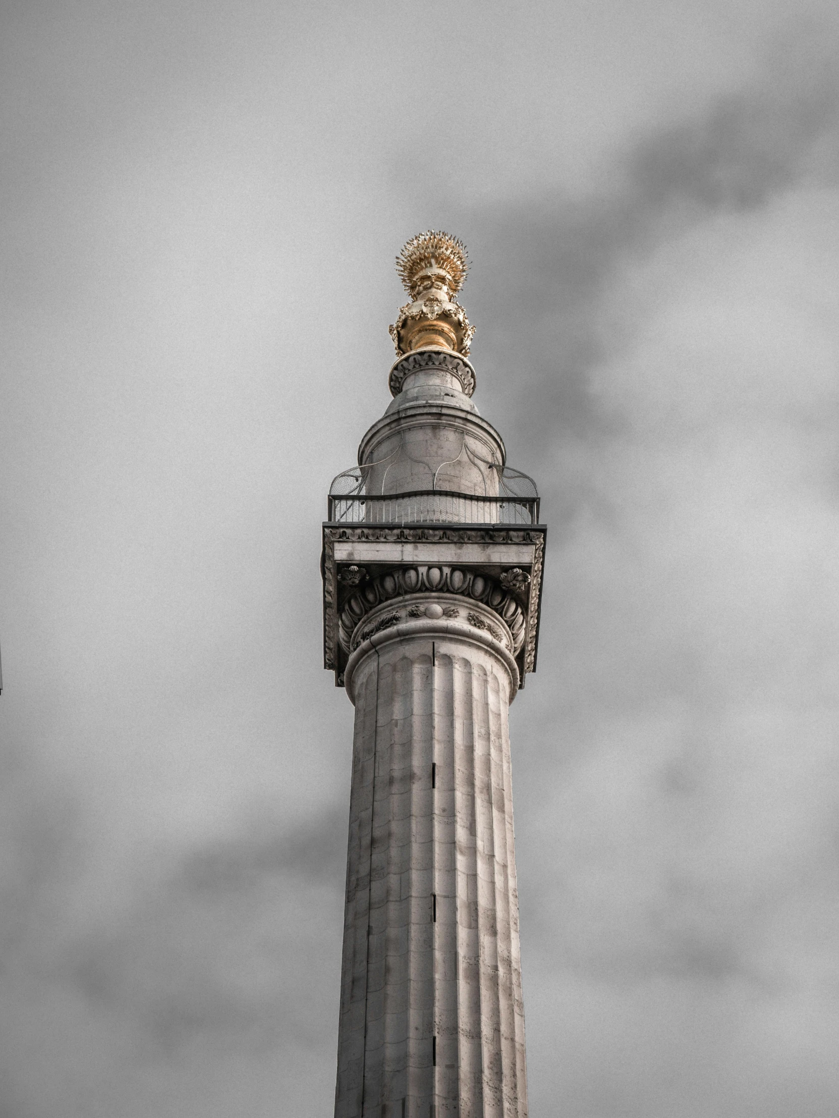 the top of a large column on a cloudy day