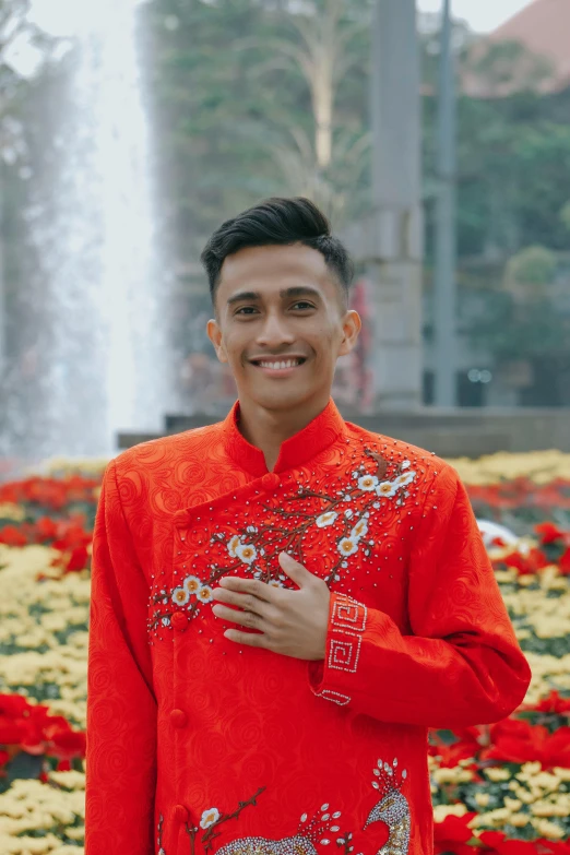 a smiling young man in an asian traditional outfit