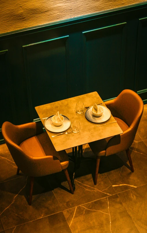 there is a table with place setting with a place setting at the dinner table