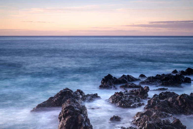 the ocean is very clean and blue with a few waves