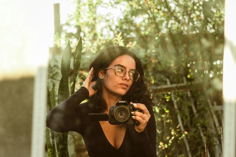 a woman with glasses is taking a picture of herself