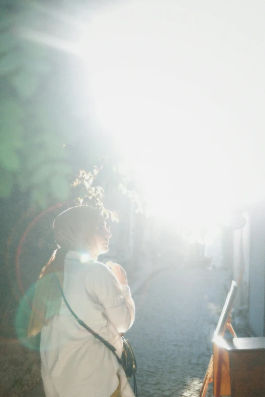 a woman in white walking on street at daytime