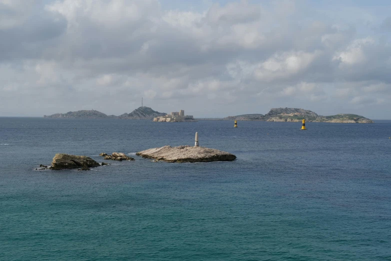 a bird that is perched on some rocks in the ocean