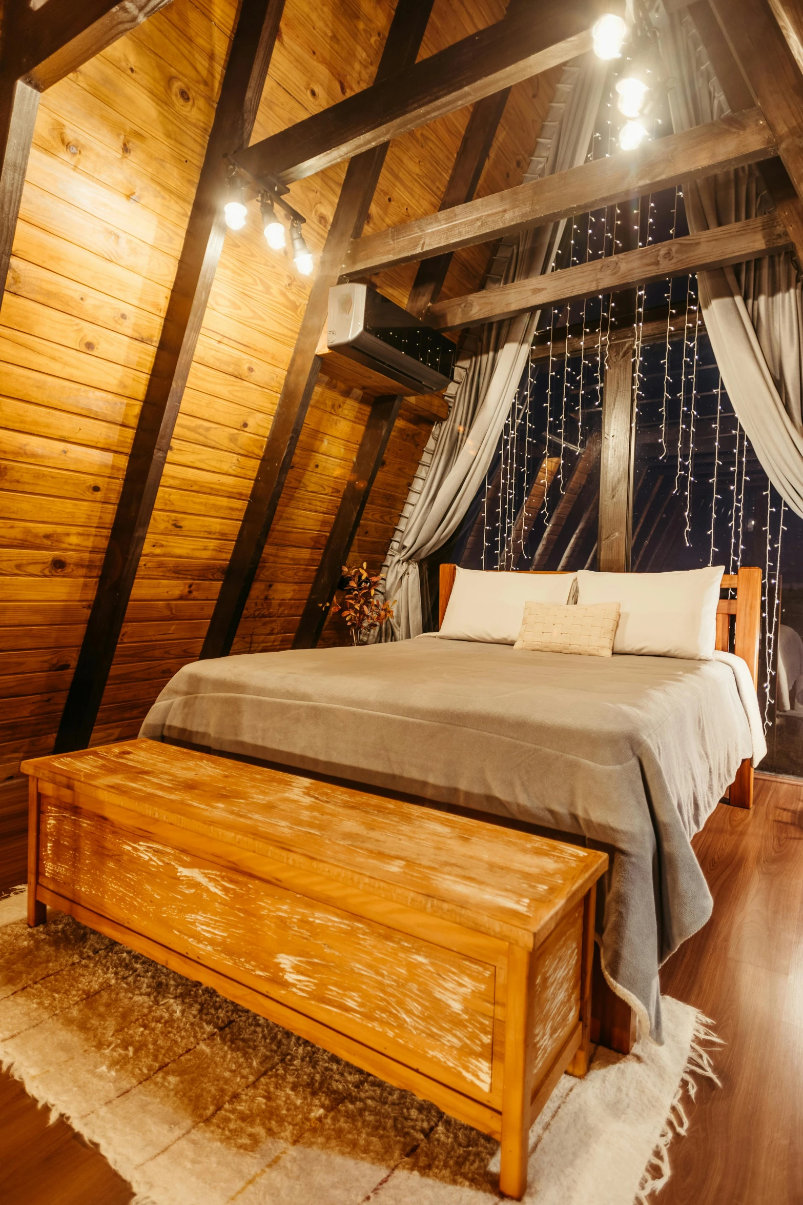 a bedroom in a house with wood flooring and walls