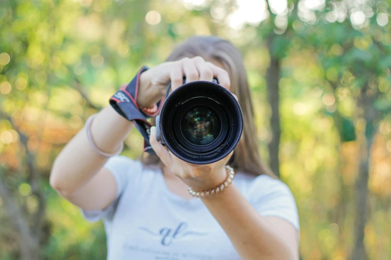 woman taking pictures of tree with a wide lens