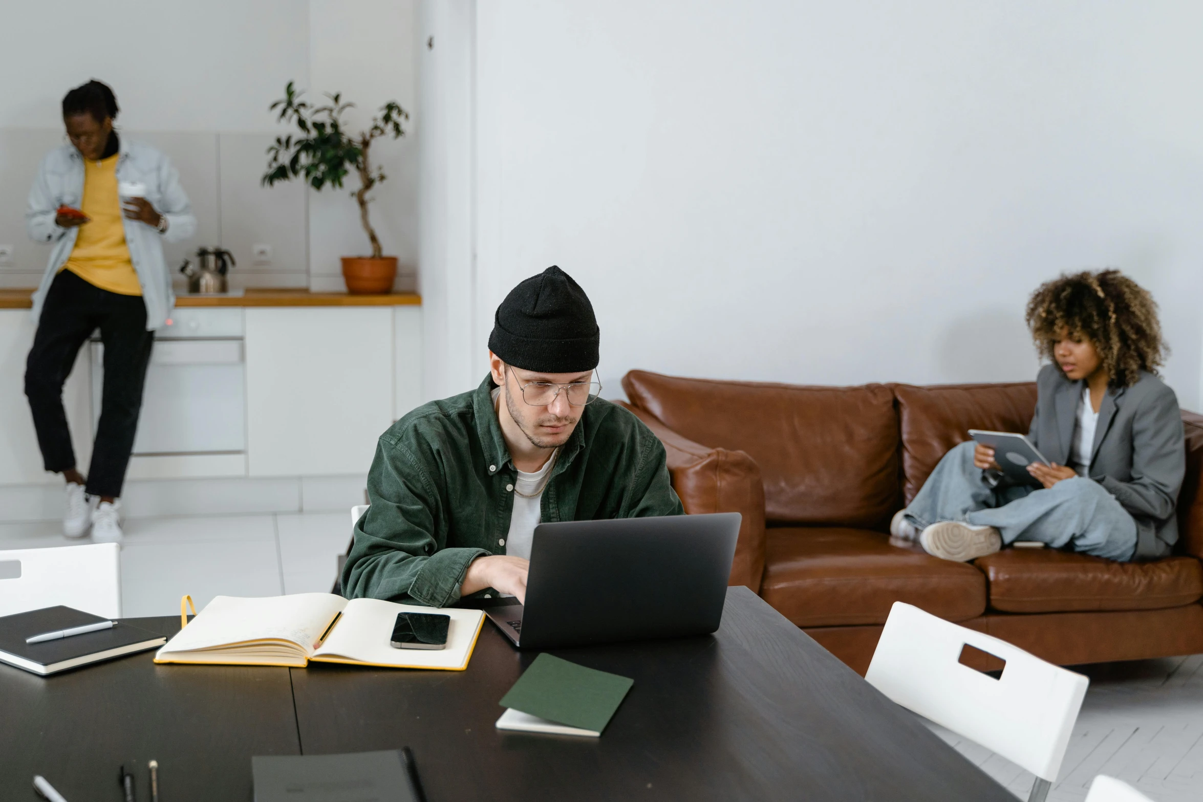 a man is working on his laptop in a modern apartment