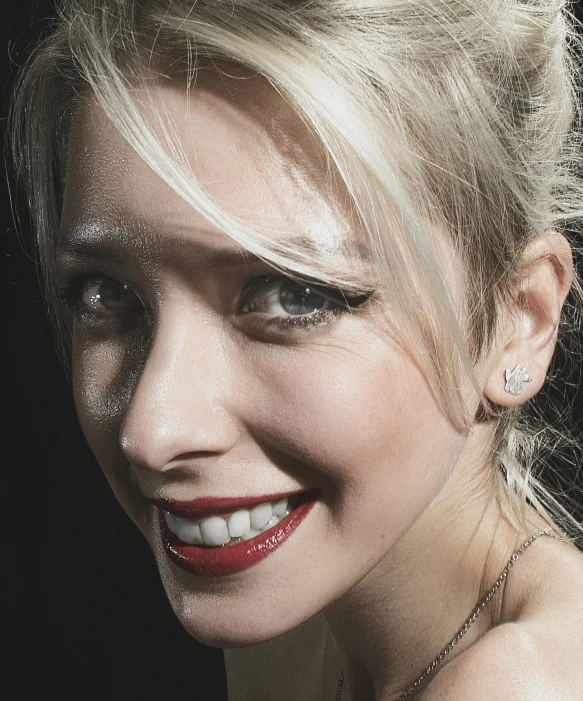 a closeup of a blonde haired woman's face