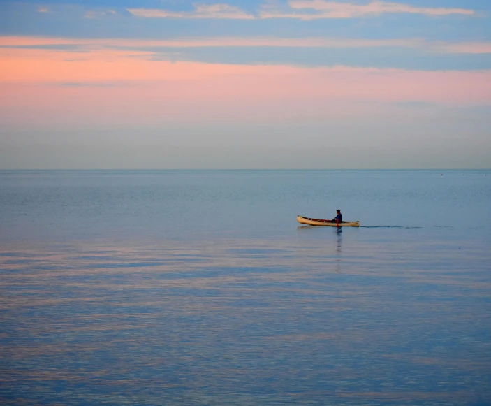 a person on a small boat on the water