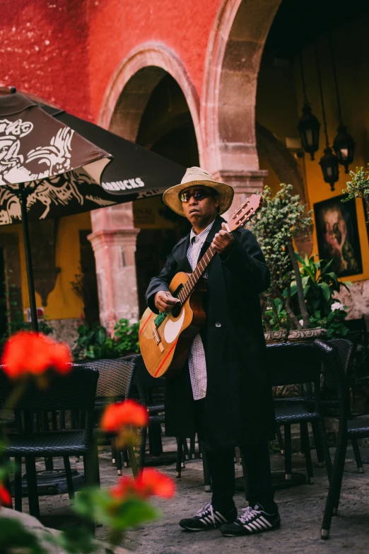 a man that is holding a guitar and a table