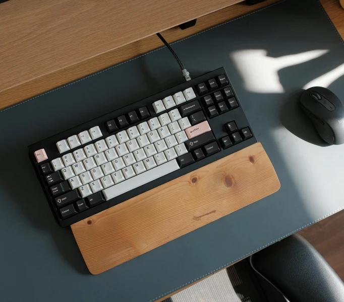 an apple keyboard and mouse on a wooden table