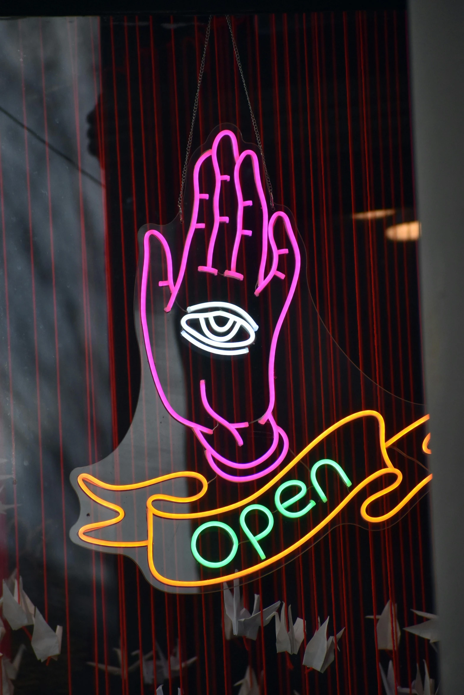 the neon sign above the door is reading open