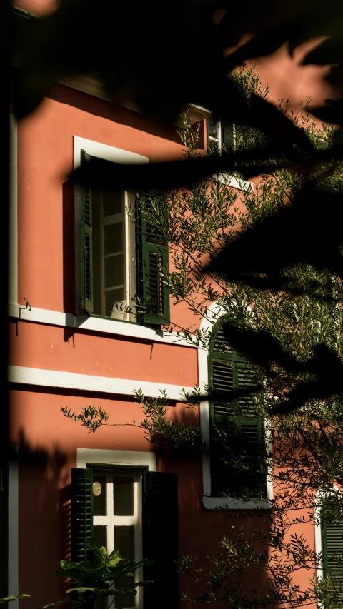 an orange and white house has black shutters