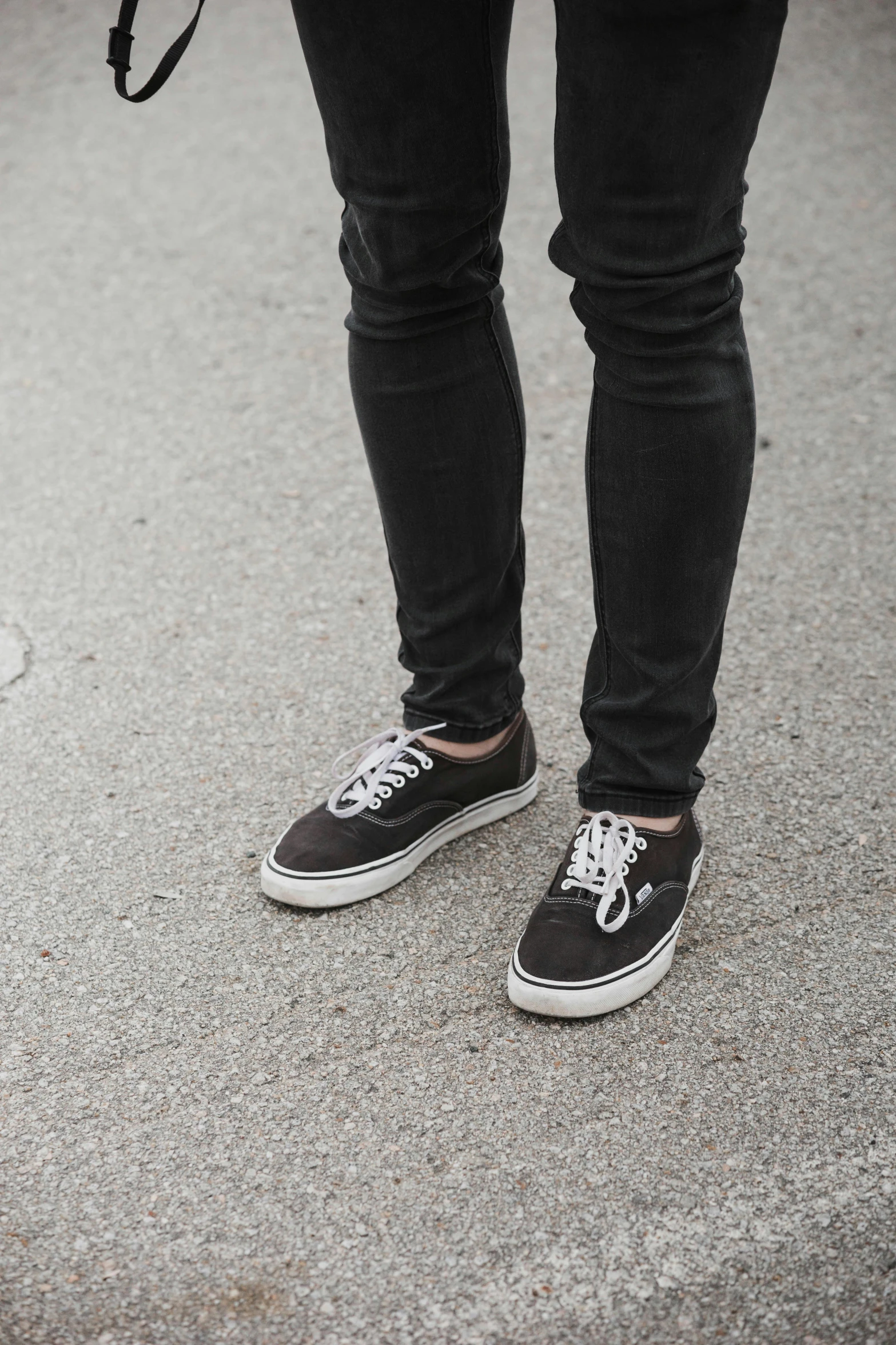 a person with shoes on is standing in the street