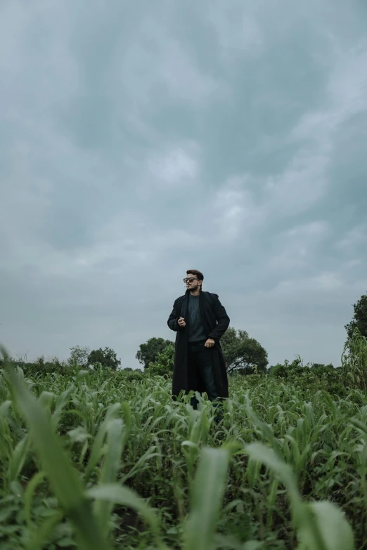 a man in a field with green grass