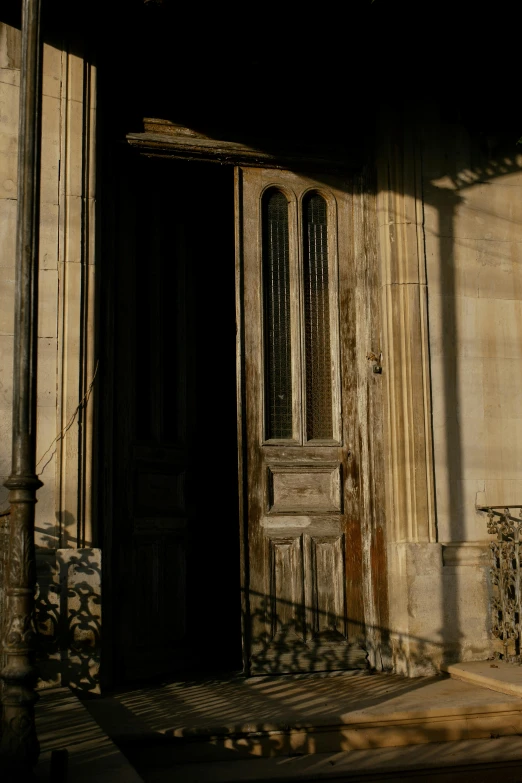 the sun casting shadows cast on an empty doorway