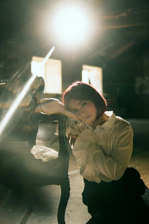 a woman sitting on a bench with her legs crossed in a chair