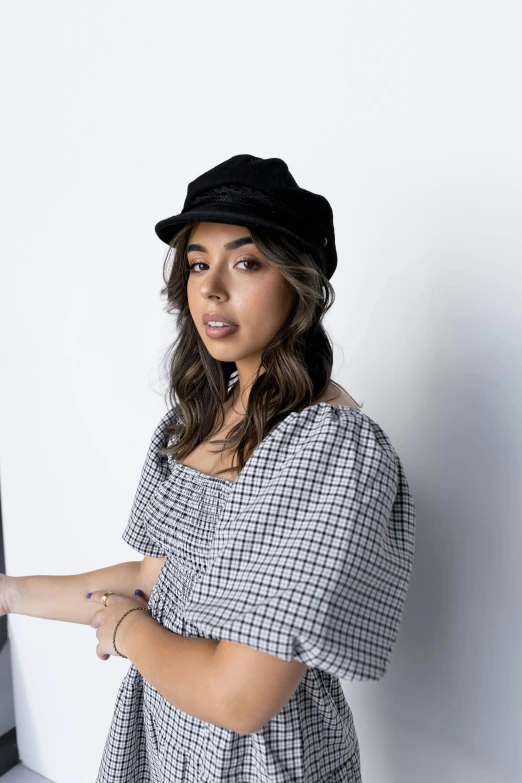 a woman is leaning against a wall