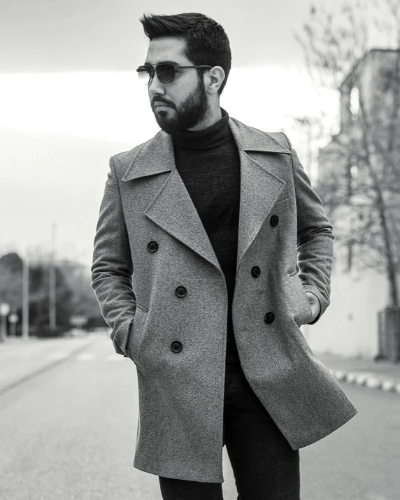 a man wearing sunglasses walking down the street