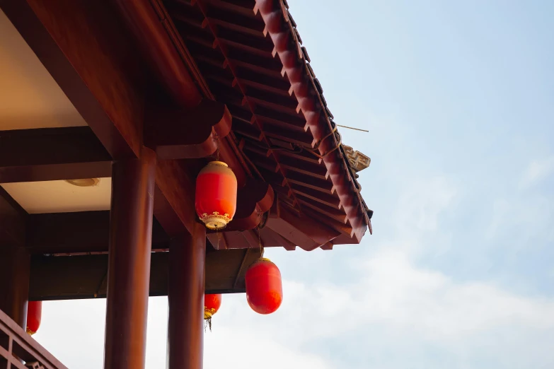 a roof that has red lanterns hanging from it