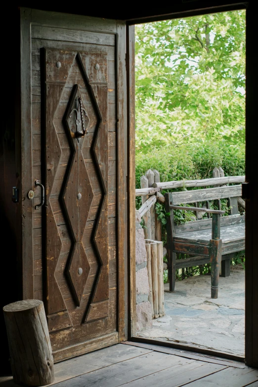 a wooden door that has the top part of a design carved into it