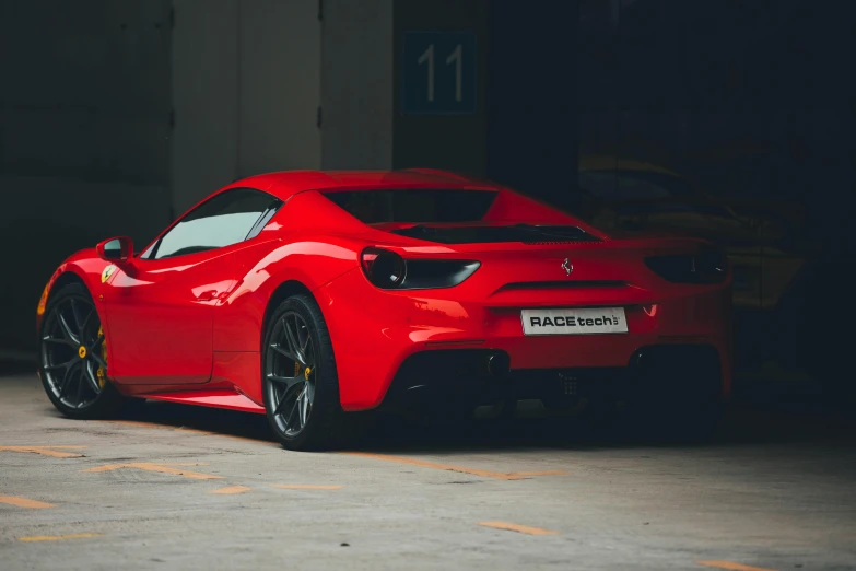 an orange sports car is parked in a garage