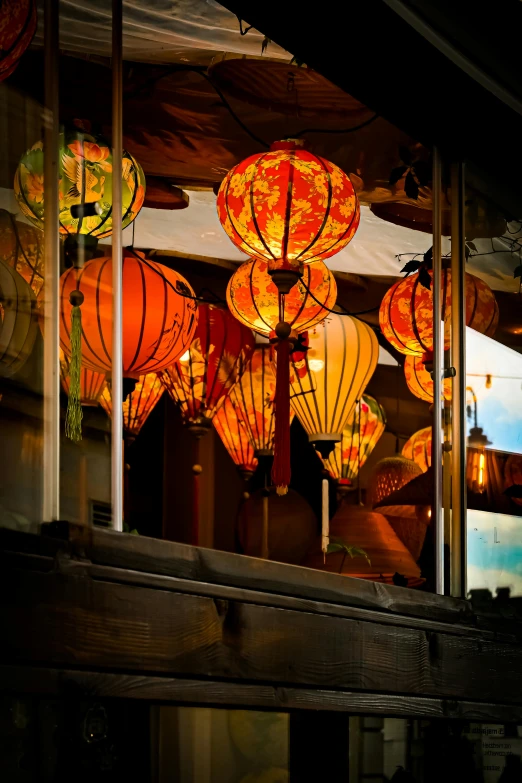 a set of lanterns are glowing brightly against the dark blue sky