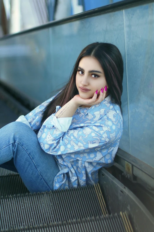 a woman leaning on an escalator with her hand on the side