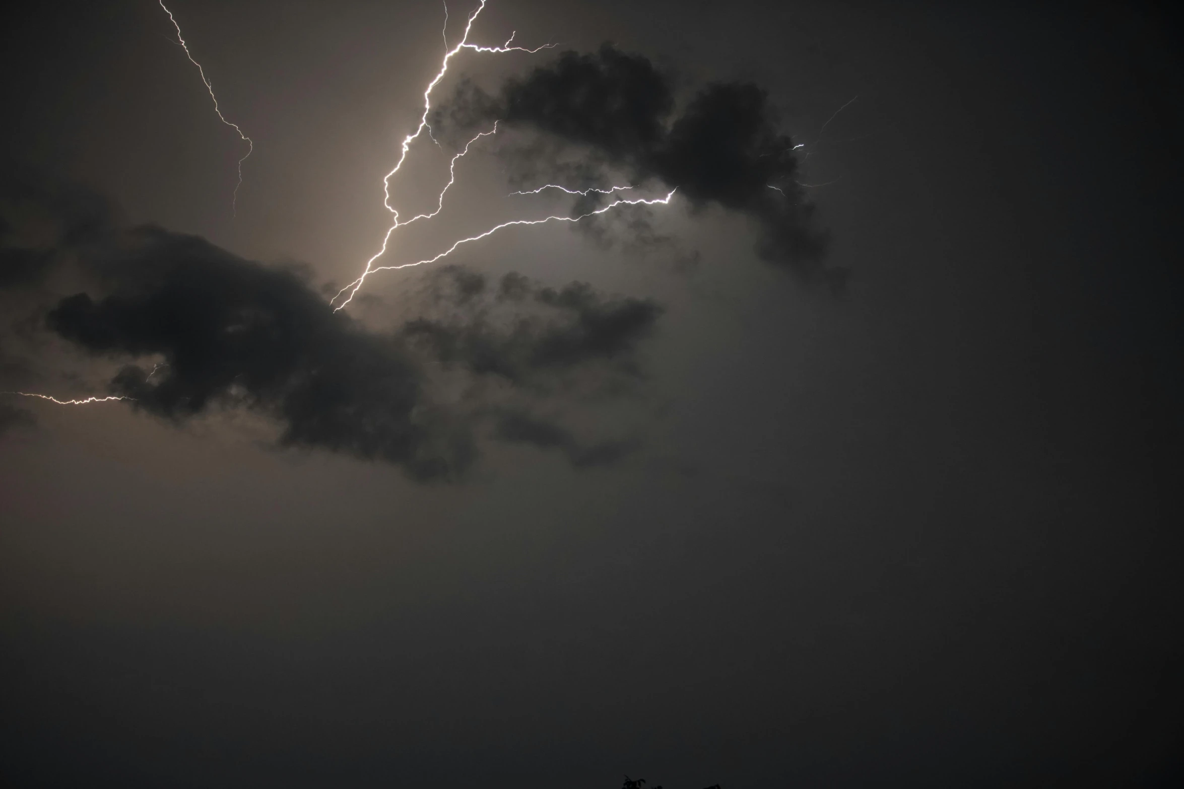 a couple of dark clouds in the sky