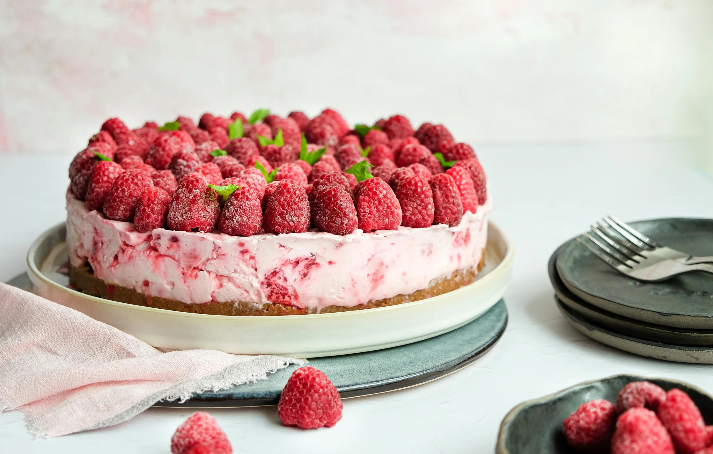 an image of a cake on the table with raspberries