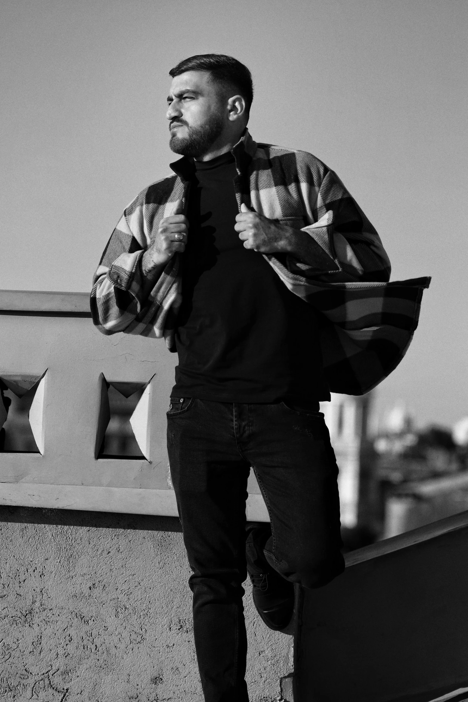 a man posing on the top of a roof