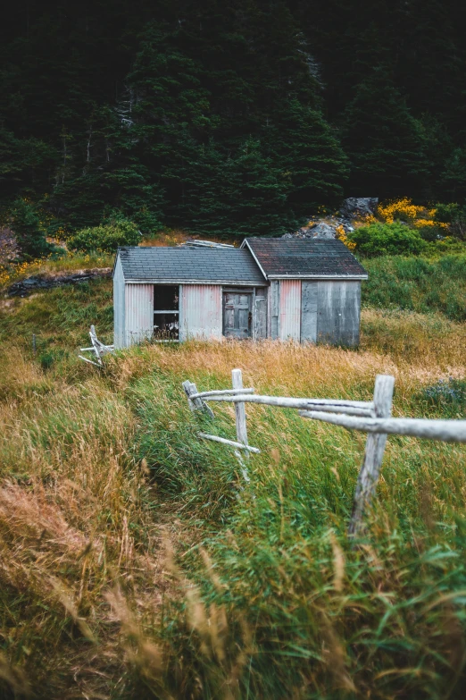 an old shack sitting out in the field