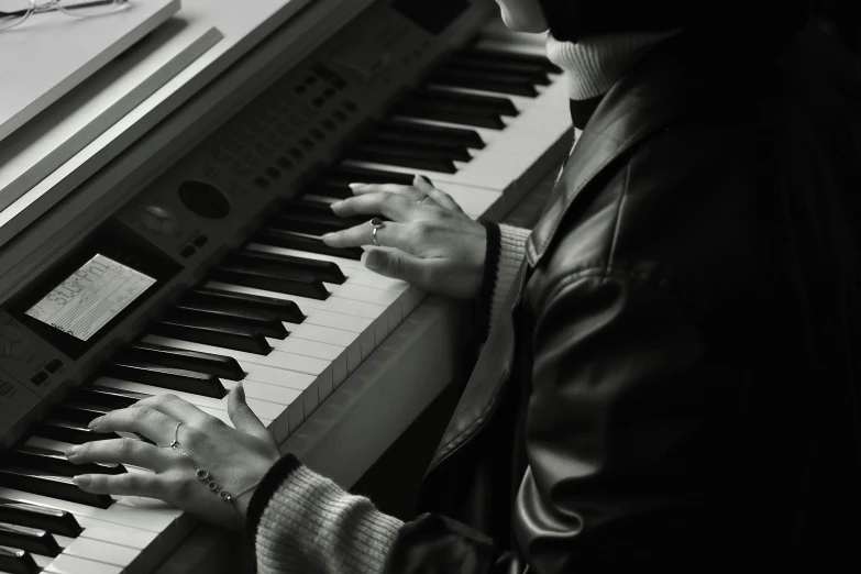 a person playing a keyboard with one hand