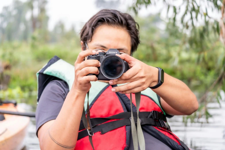 a woman taking pictures in the water with her camera