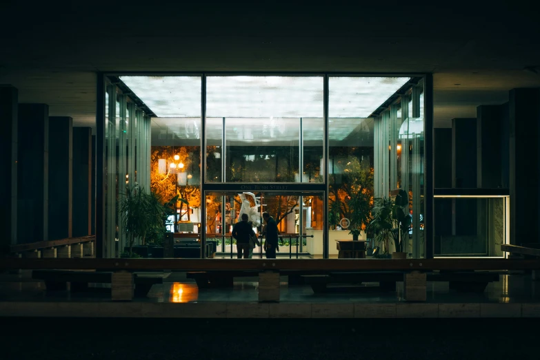 two people standing at the door of a building