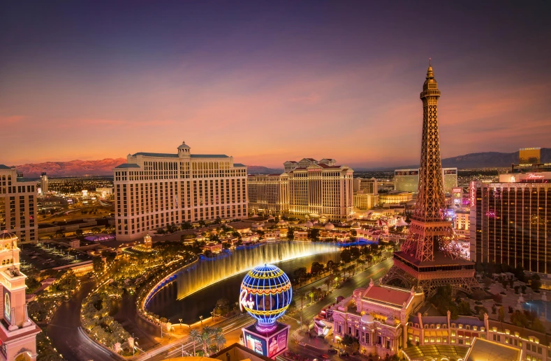 view of las vegas at night with the eiffel tower in the background