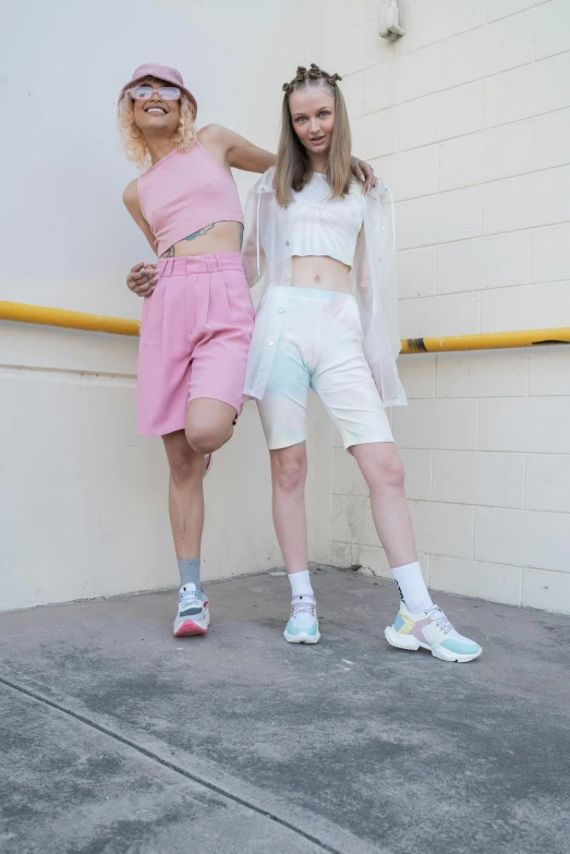 two girls dressed in pink and white posing for a po