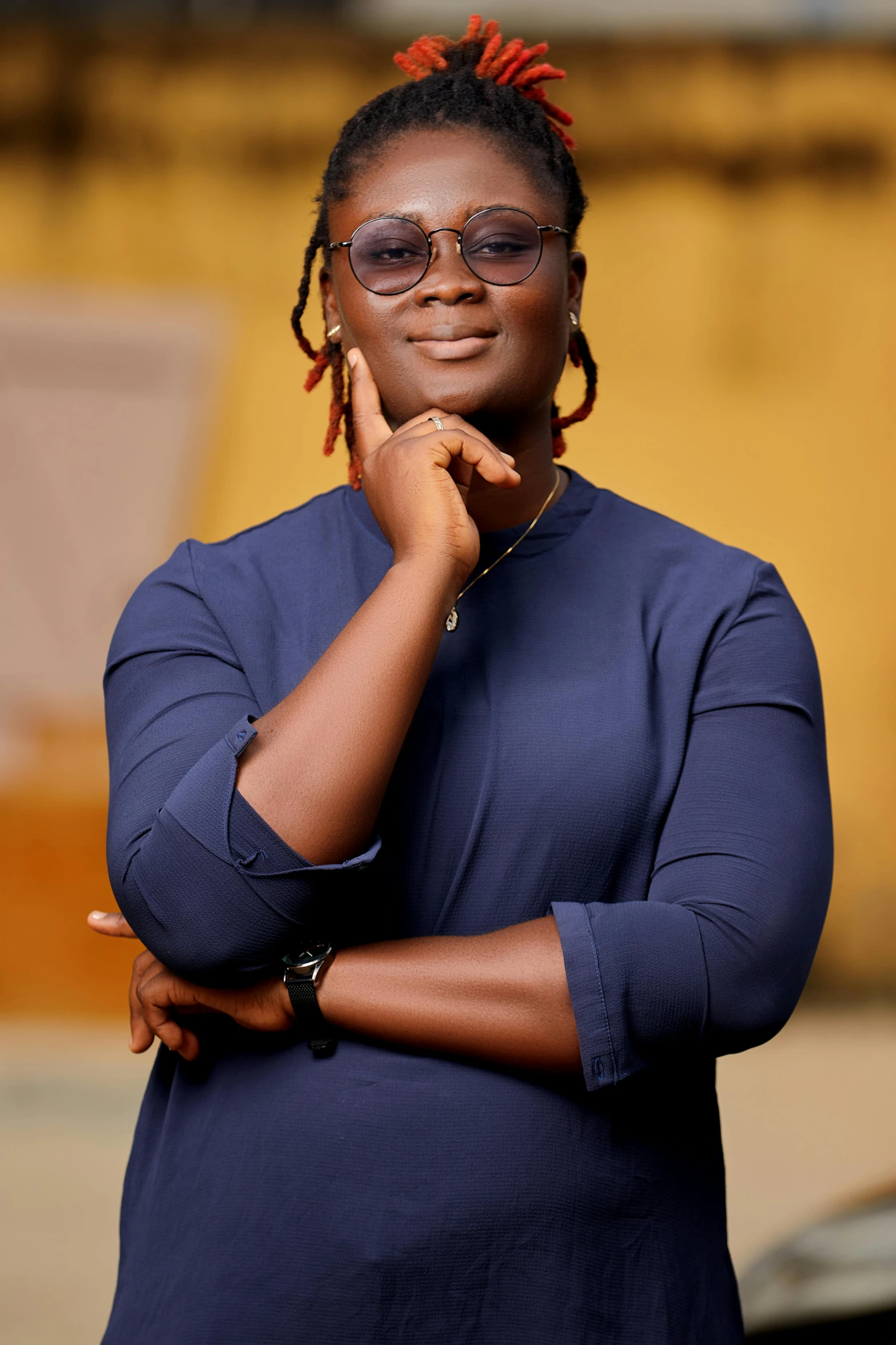 a woman wearing eye glasses is posing for a picture