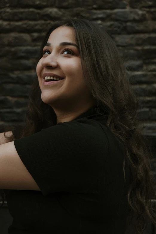 a woman is smiling while wearing a black shirt