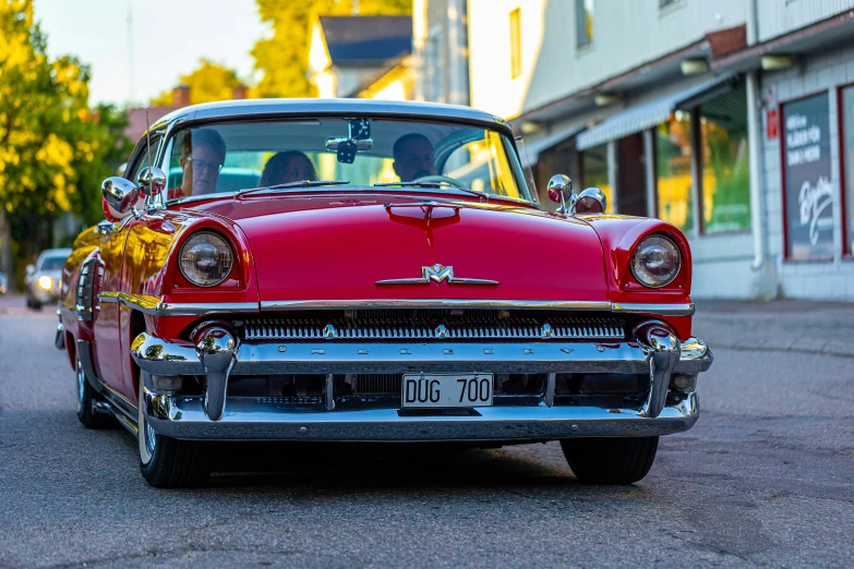 an old car sitting on the side of the road