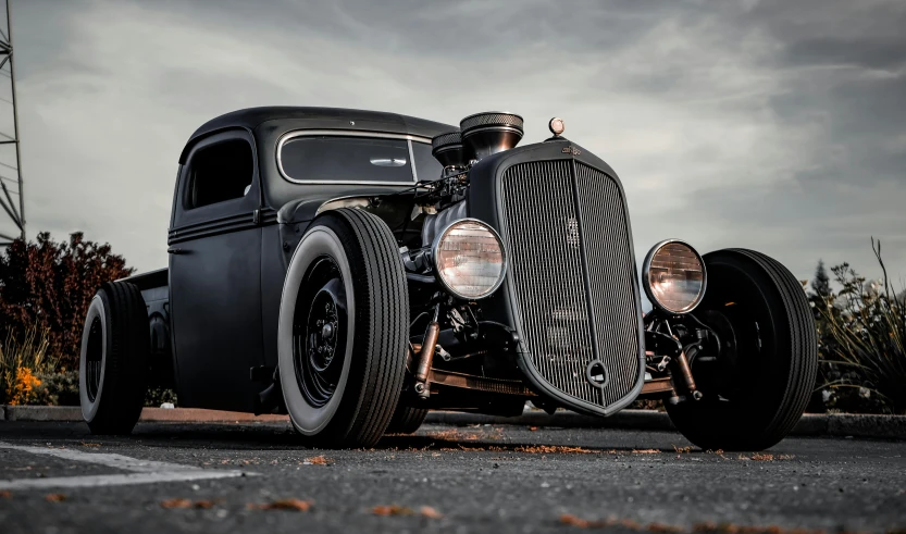 an old fashioned car is parked in a parking lot