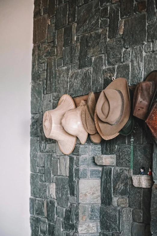 hats and booties displayed on stone wall